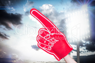 Composite image of american football player holding supporter fo