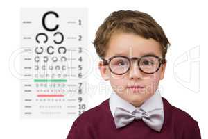 Composite image of cute schoolboy wearing reading glasses