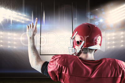 Composite image of rear view of american football player triumph