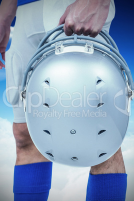Composite image of midsection of american football player handin