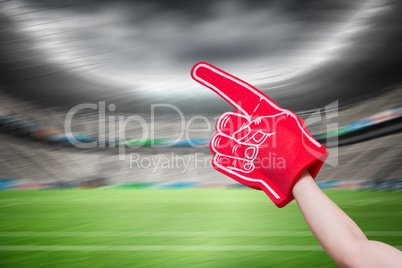 Composite image of american football player holding supporter fo