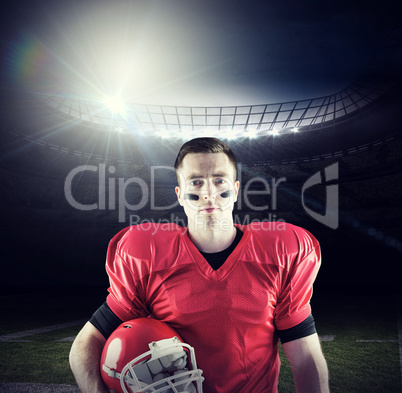 Composite image of a serious american football player looking at