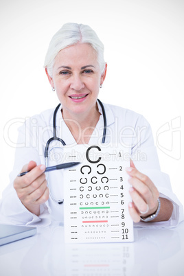 Composite image of portrait of smiling female doctor holding not