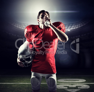 Composite image of thirsty sportsman in red jersey holding helme
