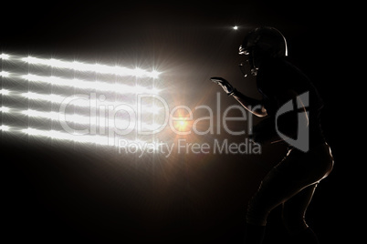 Composite image of silhouette sportsman playing american footbal