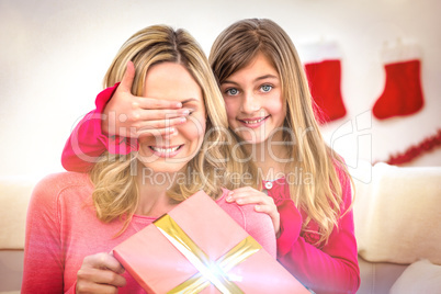 Little girl hiding gift from mother