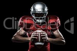 Composite image of american football player in red jersey and helmet holding ball