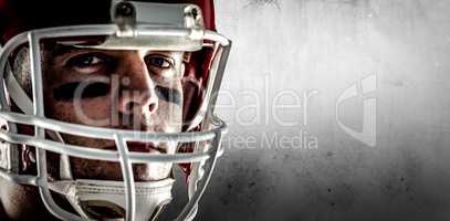 Composite image of american football player looking at camera