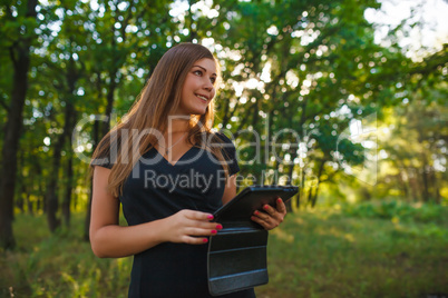 European appearance young woman brown hair in a black dress hold