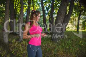 Girl European appearance in a pink shirt and gray tights listeni