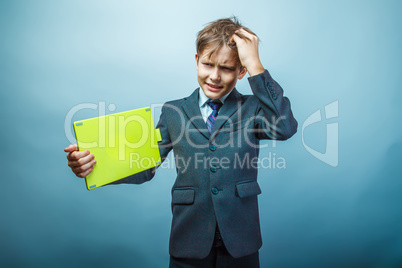 Teen boy businessman European appearance in a business suit hold