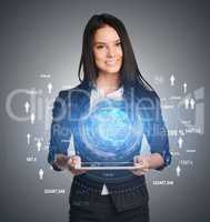 Young girl holding tablet in hands of a virtual digital globe and icons on sides