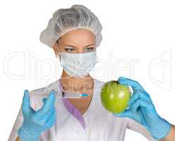 Woman holding an apple and is injected with a syringe. Genetically modified foods