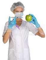 Woman holding an apple and is injected with a syringe. Genetically modified foods