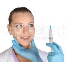 Surprised young woman looking at needle of syringe with an injection Botox
