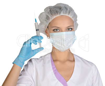 Doctor a masked holds before him syringe in hand