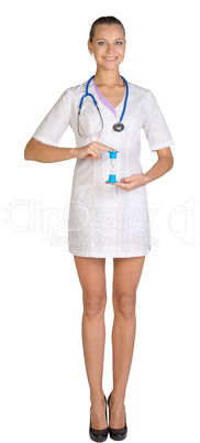 Woman doctor holding fingers hourglass. White background