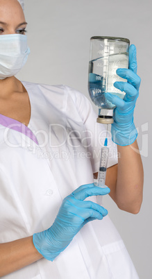 Female doctor picking up the syringe injection