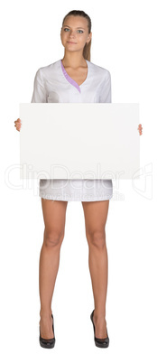 Woman doctor holds in hands blank billboard