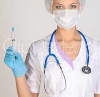 Doctor a masked holding syringe in hand