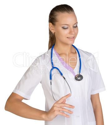 Healthcare. The woman in white coat. Smiling female doctor pointing to something or pressing imaginary button