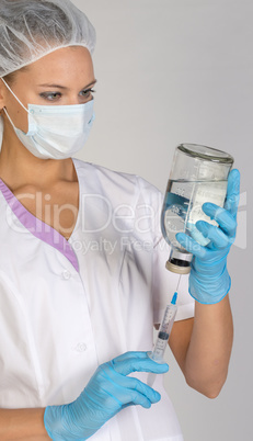 Female doctor picking up the syringe injection