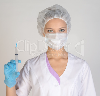 Doctor a masked holding syringe in hand
