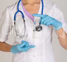 Woman doctor with stethoscope holding medical syringe