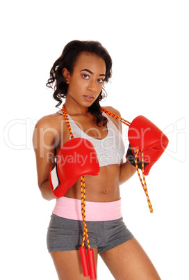 Athletic woman with rope, wearing boxing gloves.