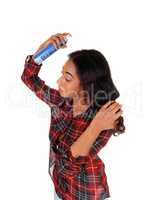 African american woman using hair spray.