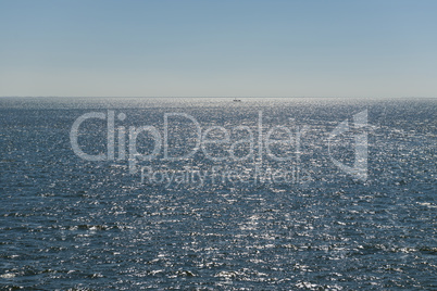 Sun over the Wadden Sea with fishing boat.