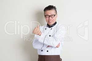 Mature Asian Chinese chef giving thumb up