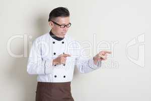 Mature Asian Chinese chef pointing