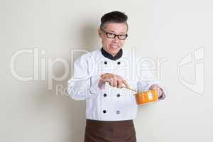 Mature Asian Chinese chef cooking