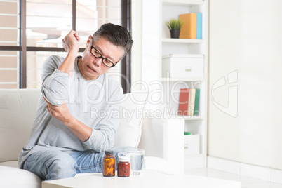 Mature Asian man elbow pain