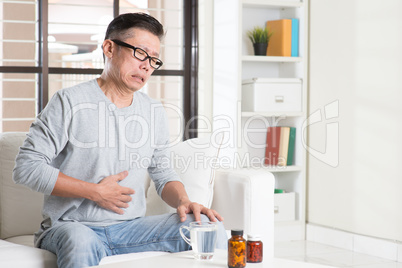 Mature Asian man stomachache