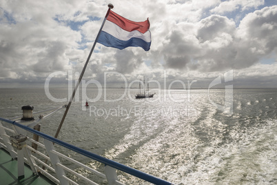 Wadden Sea with Dutch flag as seen from the ferry