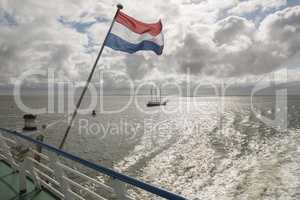 Wadden Sea with Dutch flag as seen from the ferry