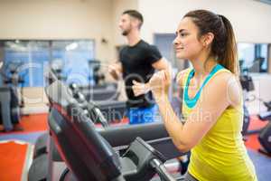 Man and woman using treadmills