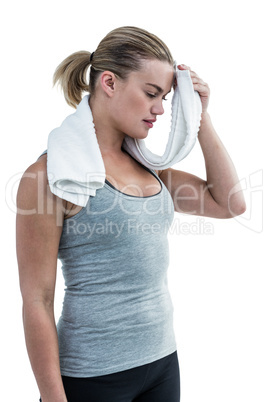 Muscular woman wiping herself with towel