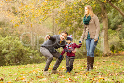 Young couple pointing something to their little boy Young couple pointing something to their little boy