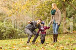 Young couple pointing something to their little boy