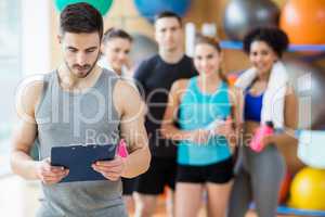 Fitness class smiling at camera in studio