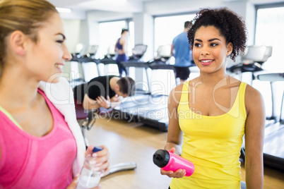 Fit women chatting and smiling