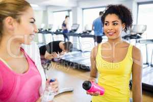 Fit women chatting and smiling