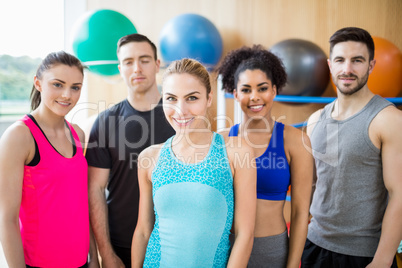 Fitness class smiling at camera in studio