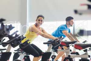 Couple using exercise bikes together