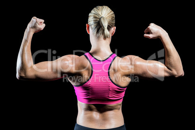 Muscular woman flexing her arms