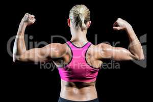 Muscular woman flexing her arms