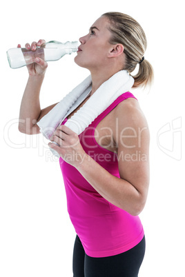 Fit woman drinking water